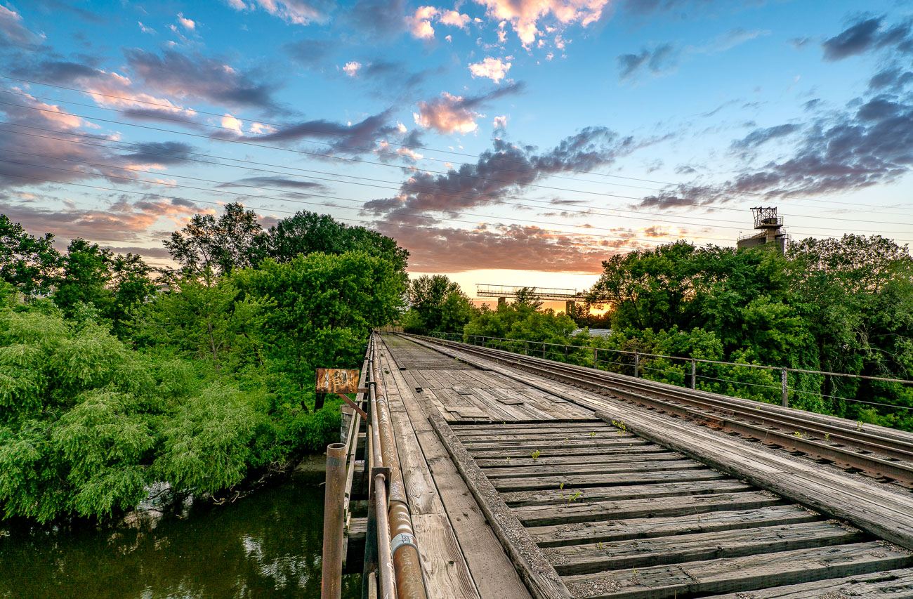 Wooden train bridge with sunset