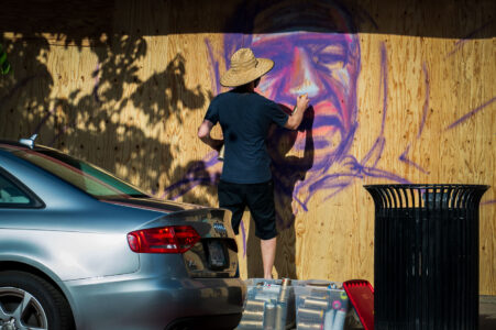 A street artist painting boards on Hennepin Ave on May 31, 2020 after days of protests following the death of George Floyd on May 25th, 2020.