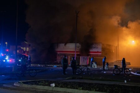 Minneapolis Police surround the burning AutoZone store during the 2nd day of protests in Minneapolis following the death of George Floyd. 

The AutoZone would be the first fire during the days of rioting.