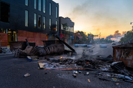 The sun rising on May 30, 2020 in Minneapolis over Lake Street. The street littered with debris from fires after the 4th day of protests in Minneapolis following the death of George Floyd.