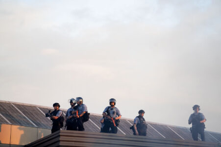 Officers on the roof of the third precinct with "less lethal" weapons.