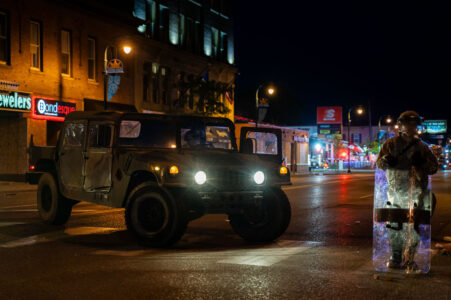 The Minnesota National Guard on Lake Street on May 30, 2020 while Minneapolis Fire Department puts out nearby fires on the 4th day of protests in Minneapolis following the death of George Floyd.