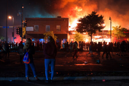 GM Tobacco and other buildings burn on Lake Street burning during the 3rd day of protests in Minneapolis following the death of George Floyd.