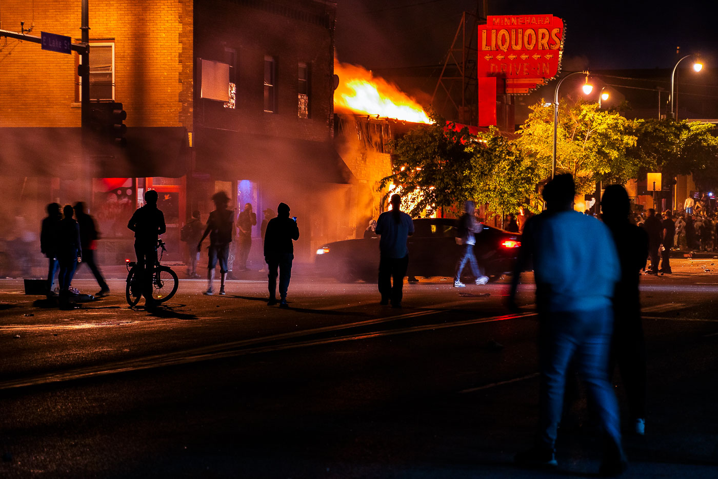 Protesters on Lake Street while buildings burn