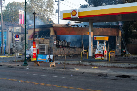 A car drives by a Shell gas station on Lake Street in Minneapolis on the morning of May 30, 2020 after nights of fires in Minneapolis.