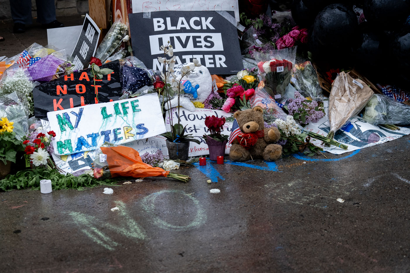 Signs flowers and bears left at George Floyd memorial