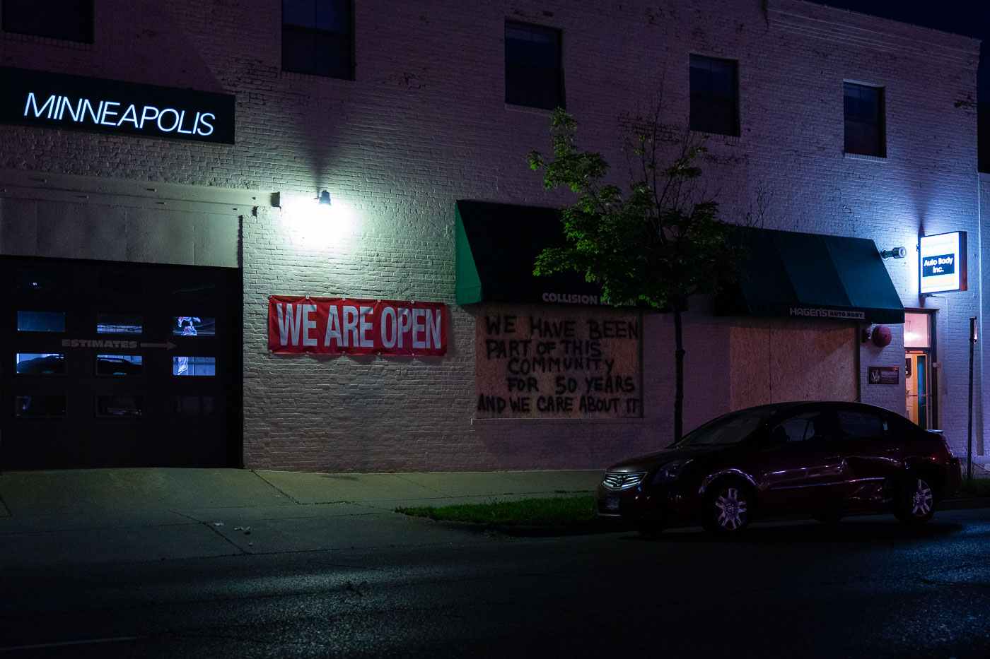 We are open sign on auto body shop on Nicollet Ave