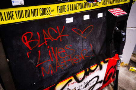 Black Lives Matter written on the gas pump at the Speedway gas station across from where George Floyd was killed in Minneapolis Police custody on May 25th, 2020.