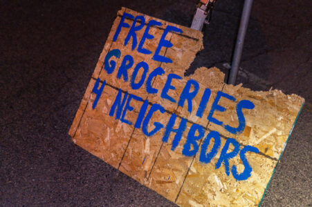 A sign on the streets of Minneapolis offering groceries to neighbors.