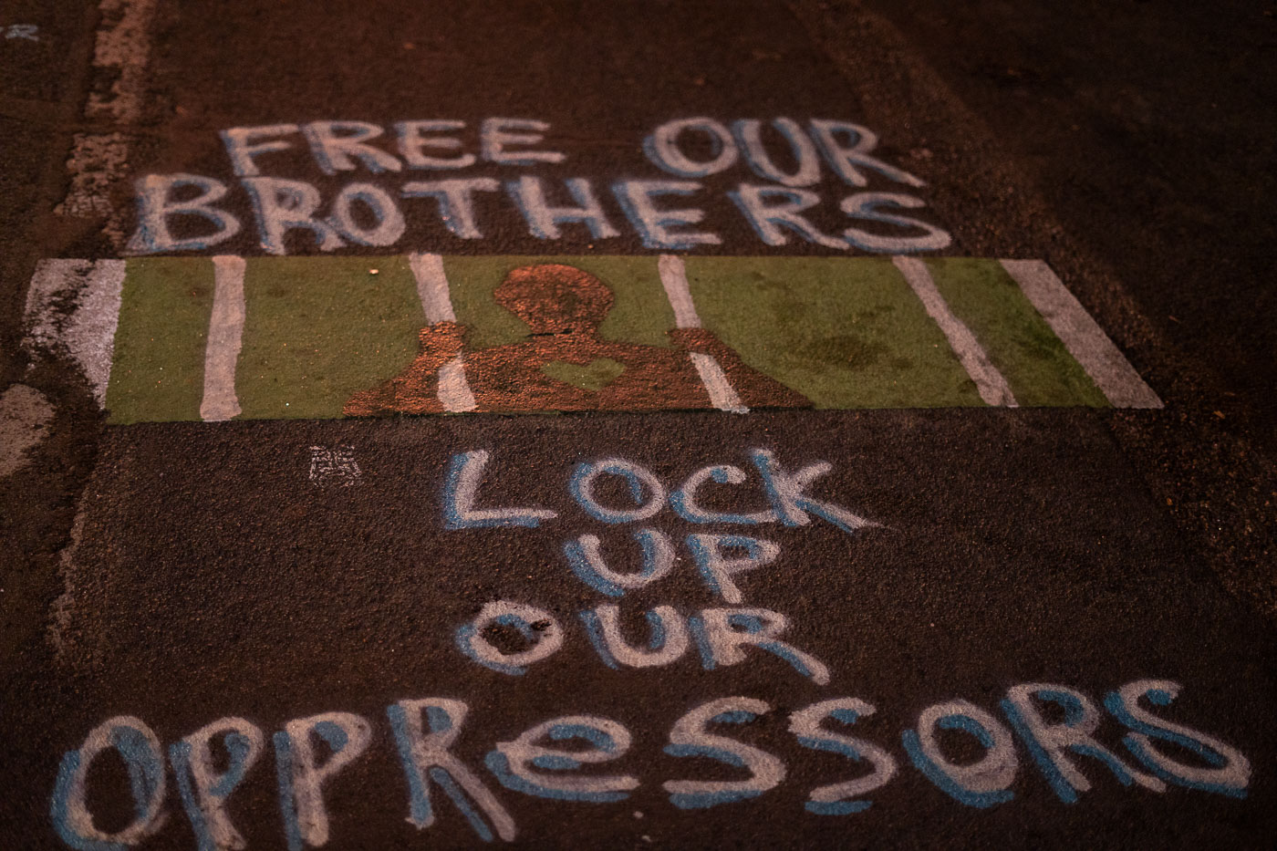 Free our brothers, Lock up our oppressors graffiti