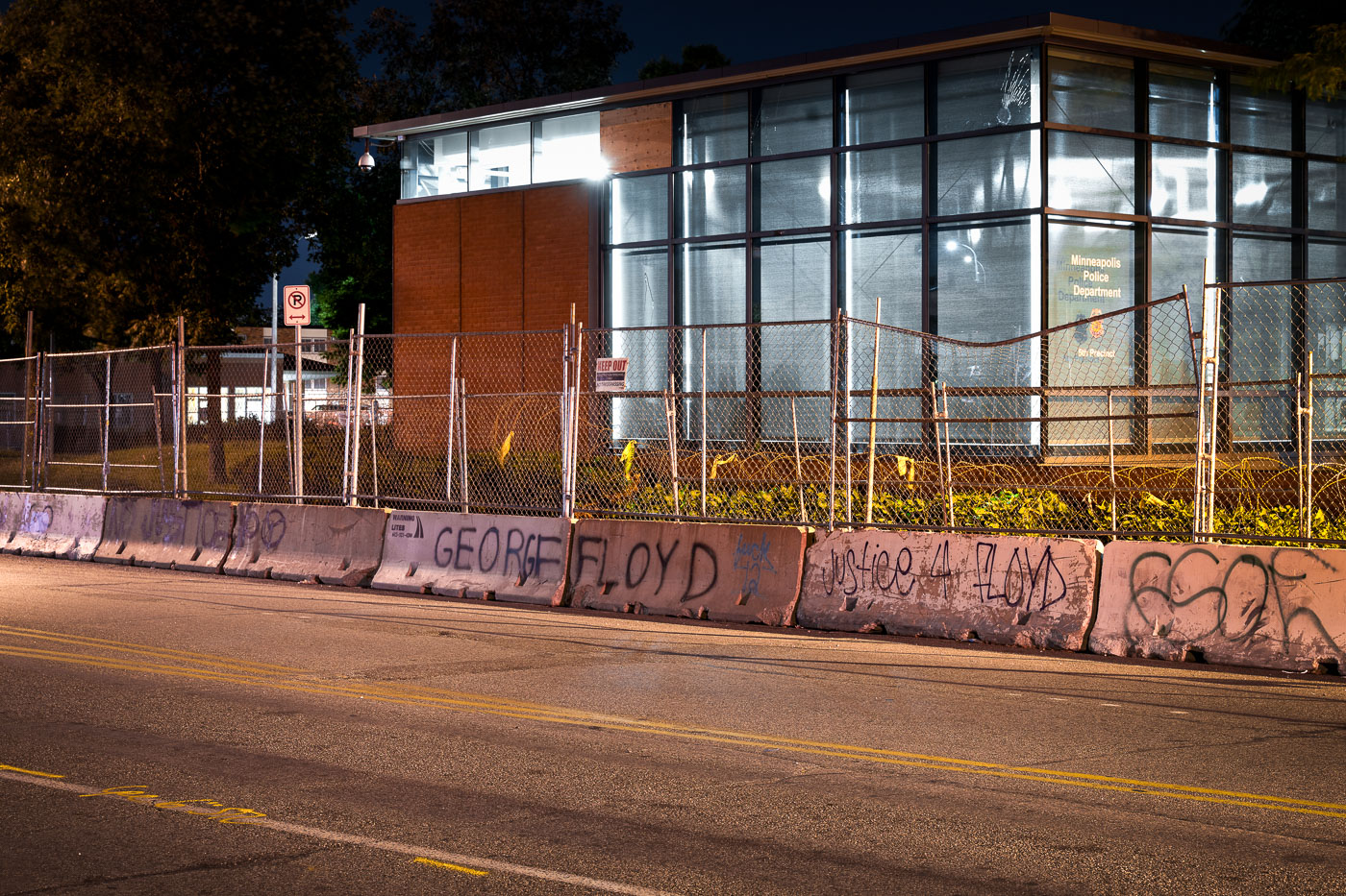 George Floyd written on concrete barricades around police station