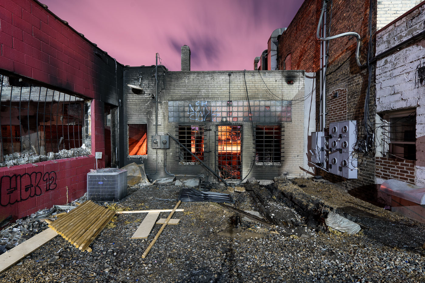 Night photo of burned out building during riots