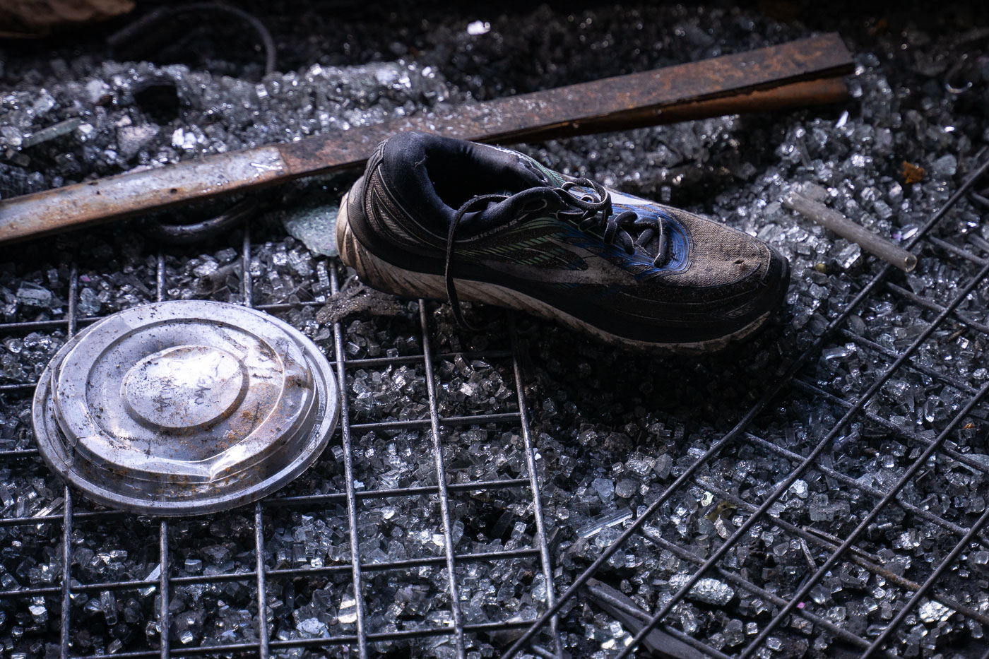 A shoe sits on floor of burned out building