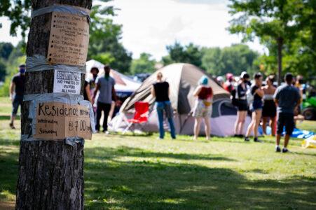 Signs on a tree located near the entrance to the Powderhorn East homeless encampment in South Minneapolis. The encampment was cleared by Minneapolis Police on July 21, 2020.