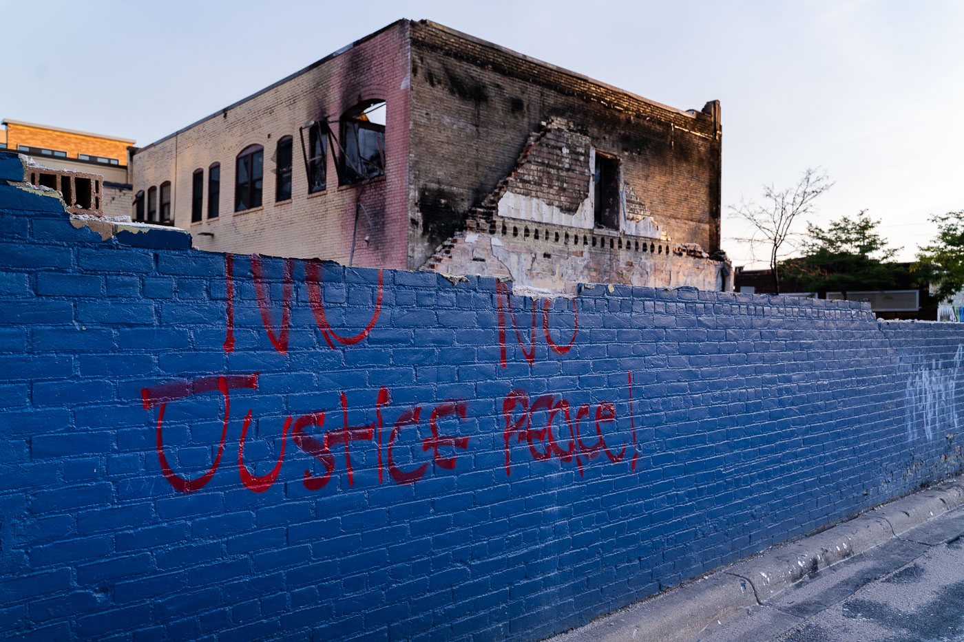 No Justice No peace on whats let of a burned building