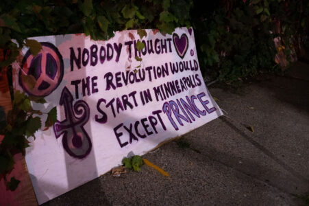 A board in front of a home that reads “Nobody thought the revolution would start in Minneapolis except Prince”.