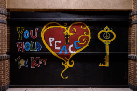 Painted boards on the CVS on Lake Street in Uptown Minneapolis. “You hold the key” “Peace”