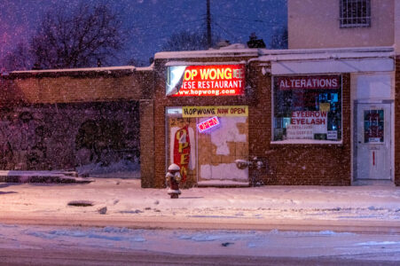 Hop Wong Chinese Restaurant on Chicago Ave in Midtown Minneapolis during a heavy snowfall.