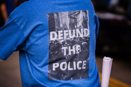 Protester wearing a "Defund the police" shirt in Minneapolis during a protest following the announcing of Joe Biden winner of the Presidential election against Donald Trump.