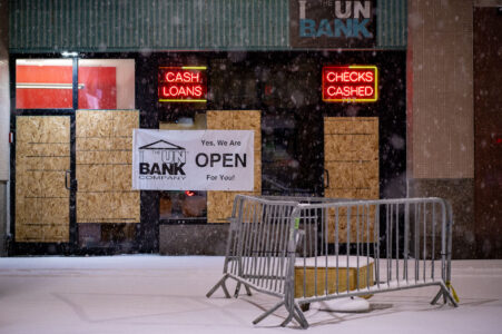“Yes, we are open for you” banner on a boarded cup UnBank branch in Downtown Minneapolis.