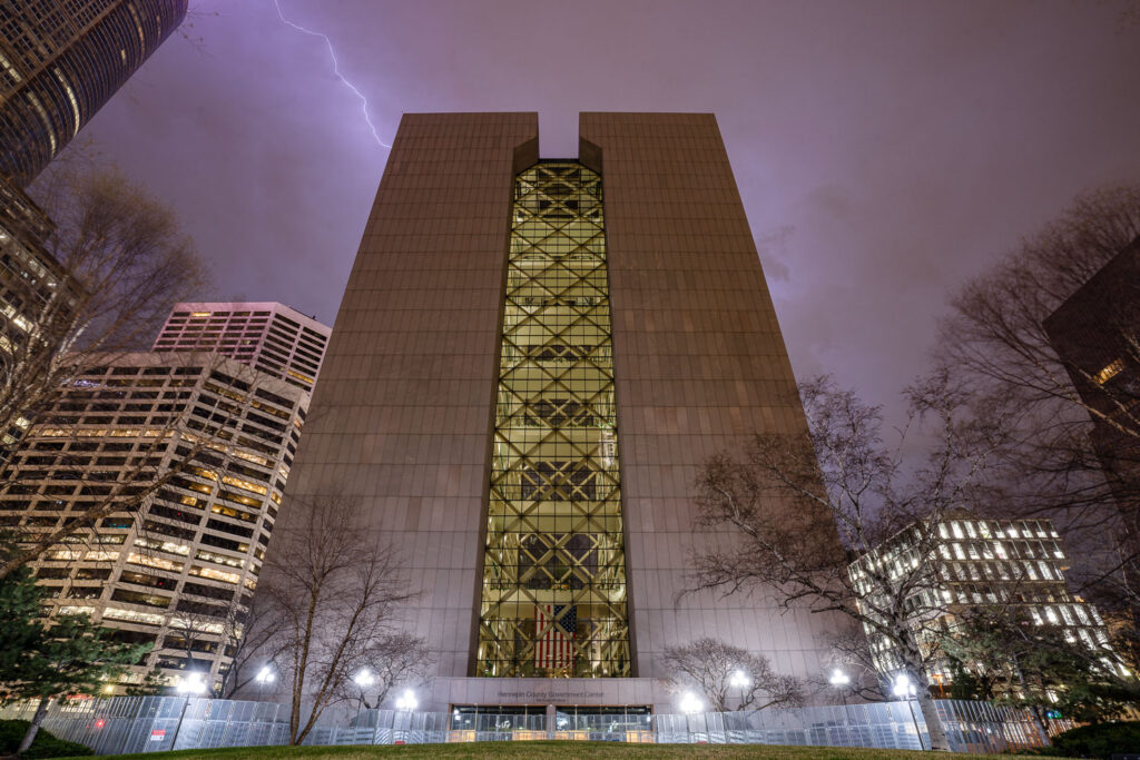 The skies over Hennepin County Government Center lit up by lightning. The heavily guarded and fortified courthouse in Downtown Minneapolis is where the Derek Chauvin murder trial is taking place. Chauvin is charged in the May 25th, 2020 murder of George Floyd.