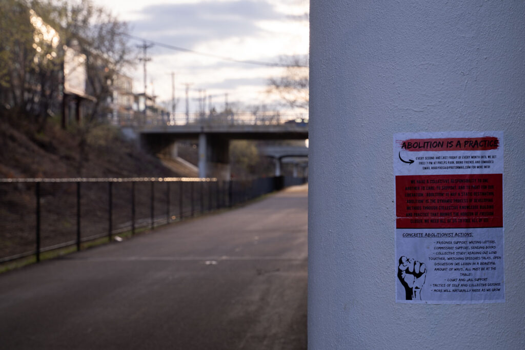 A police abolition sign pasted under a bridge on the Minneapolis Midtown Greenway.