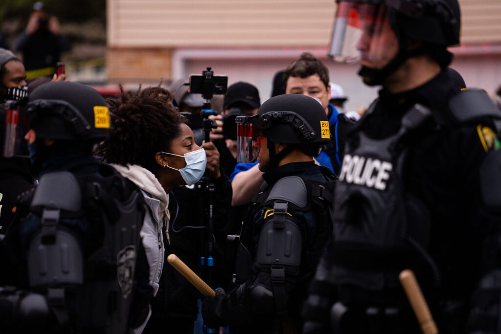 A protester confronts a Brooklyn Center Police Officer following the officer involve shooting death of Daunte Wright.
