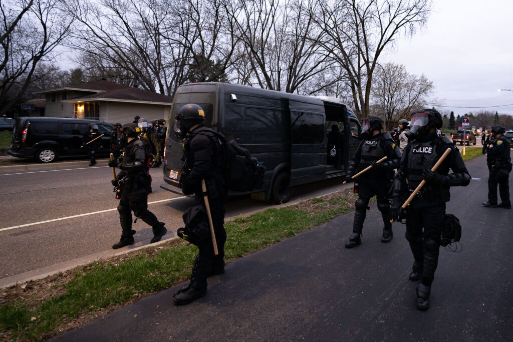 Police in riot gear arrive where protesters are gathered following the death of Daunte Wright.