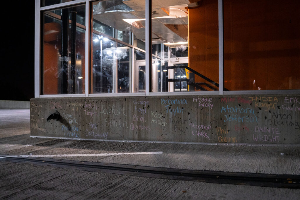 The names of others effected by police violence written on the top of the parking ramp.