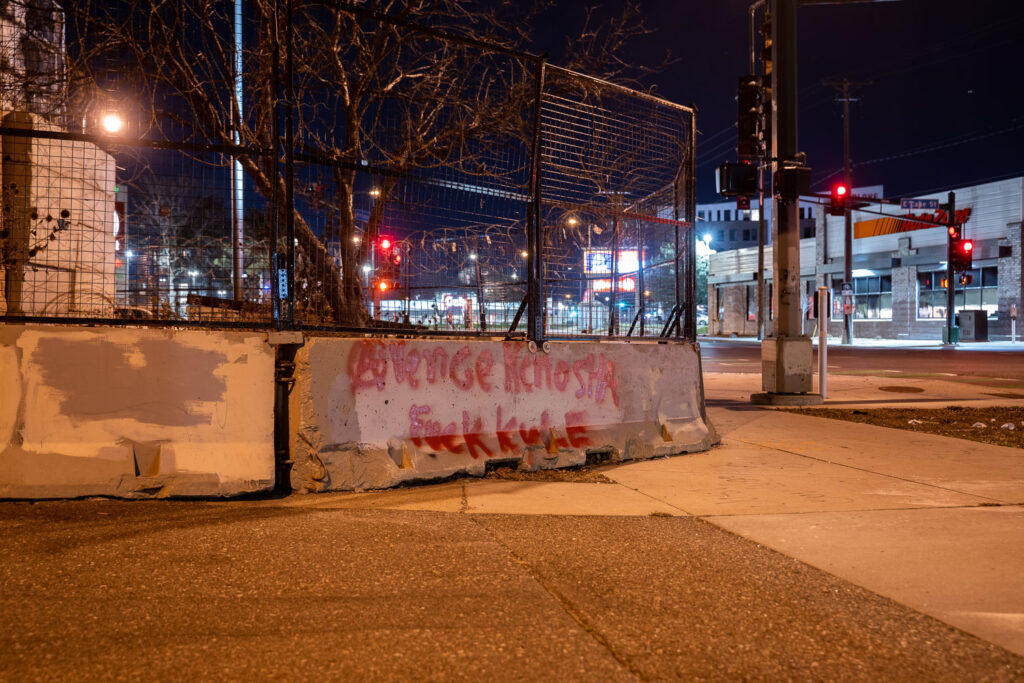 "Avenge Kenosha" written on the barriers surrounding the third precinct.