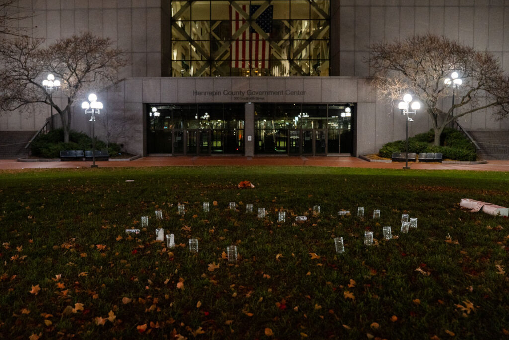 Candles in a shape of a heart outside the courthouse where jury selection has begun in the Kim Potter trial.