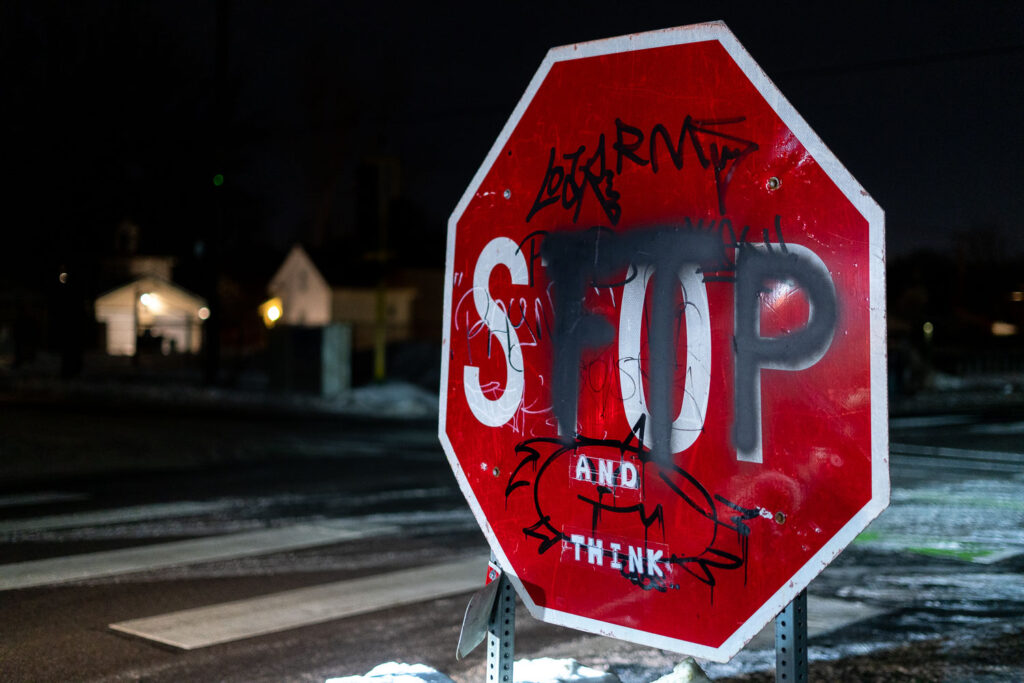 A stop sign with graffiti on it in Minneapolis.