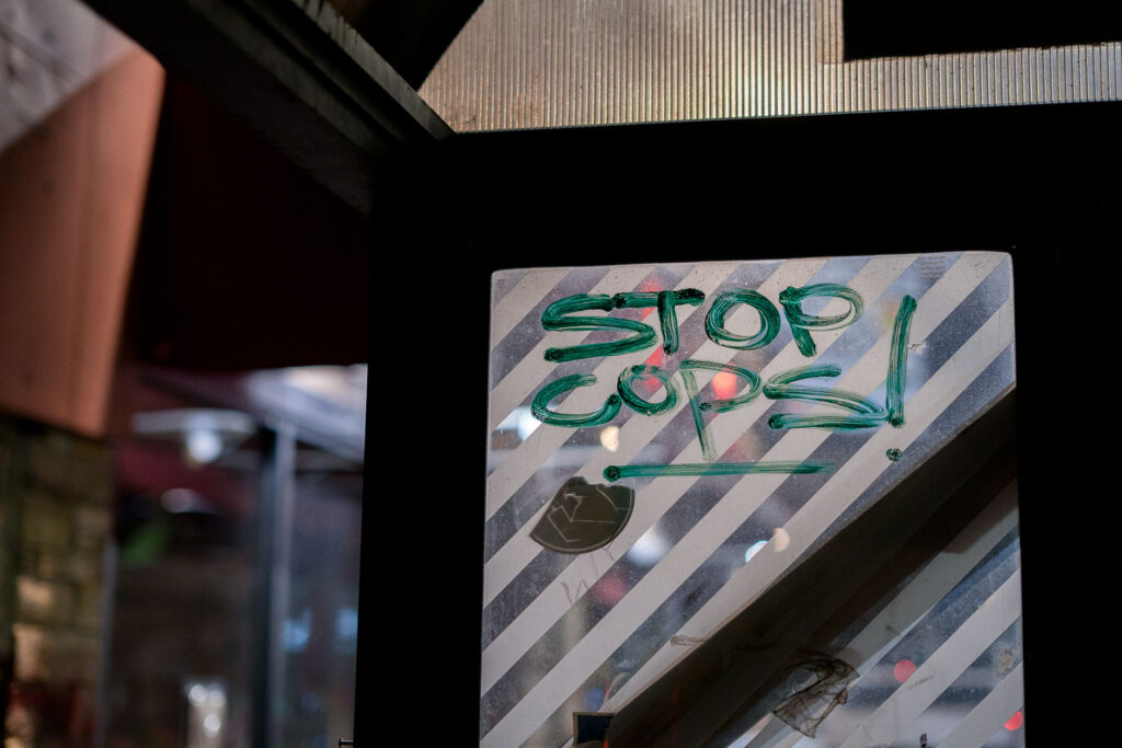 Stop Cops! written on a former bus shelter at George Floyd Square.