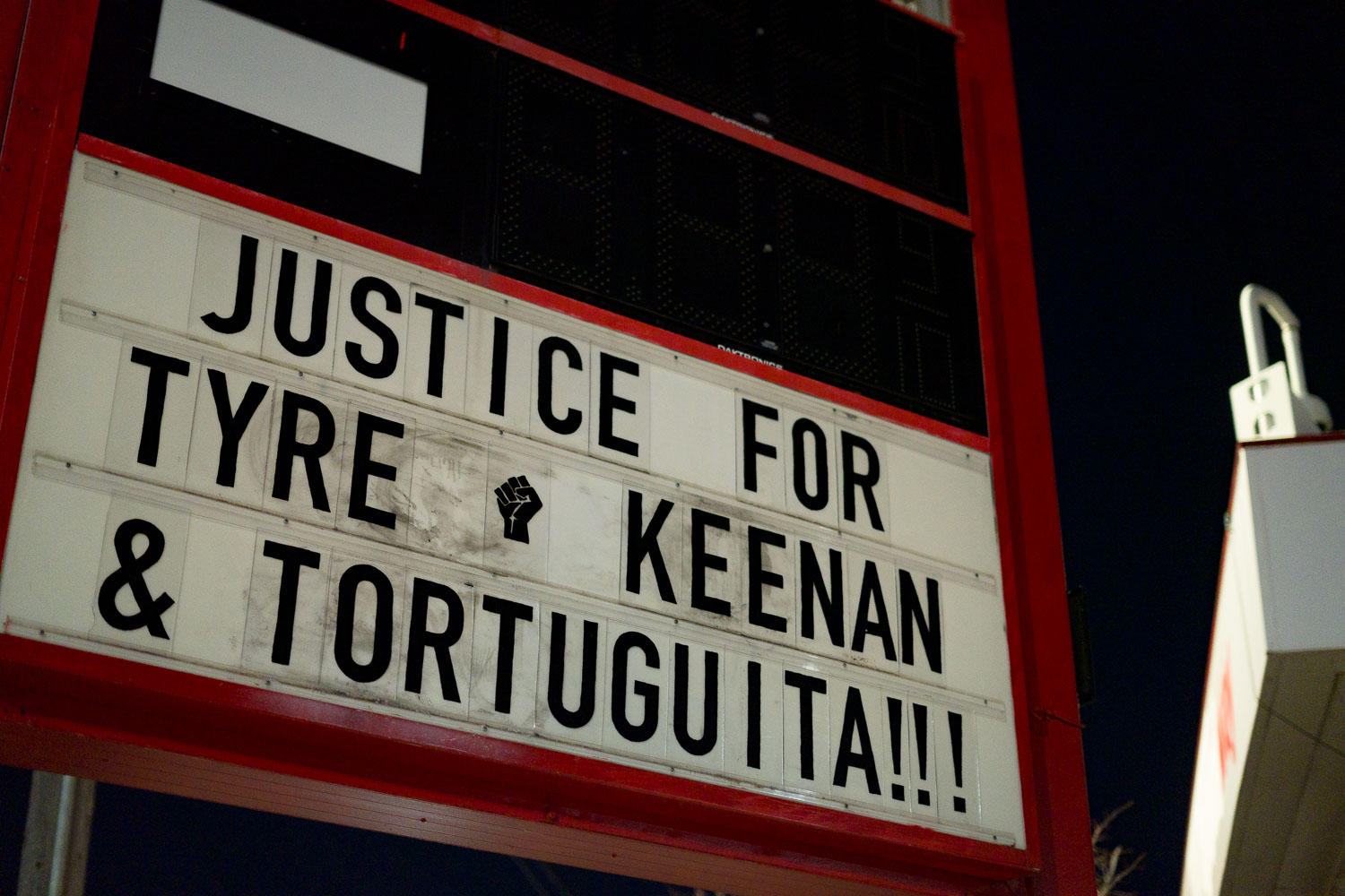 The signage at "The Peoples Way" reading "justiec for Tyre, Keenan & Tortuguita!!!"