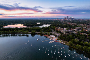 Sailboats on Bde Maka Ska in Minneapolis during sunset. Lake of the Isles seen in the distance.