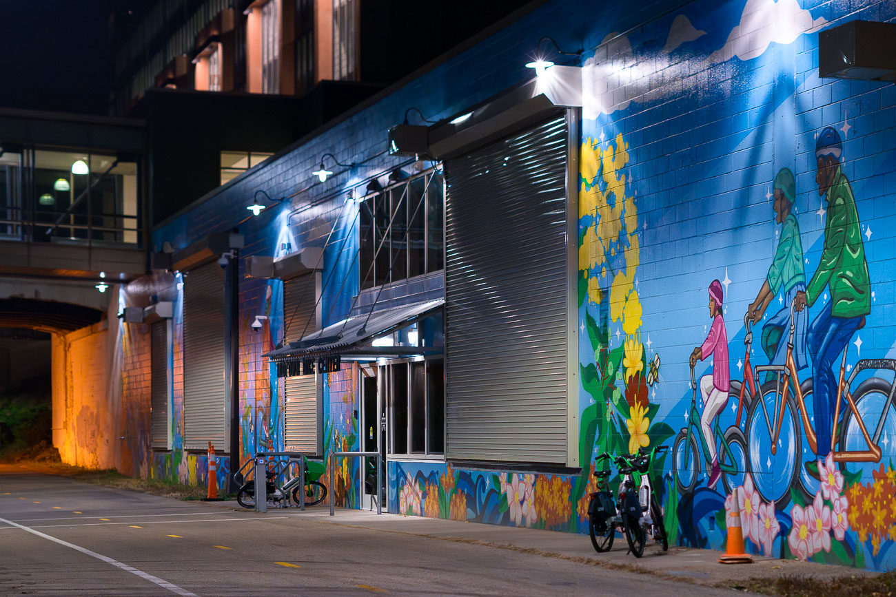 A mural of bikers on a night trail at night