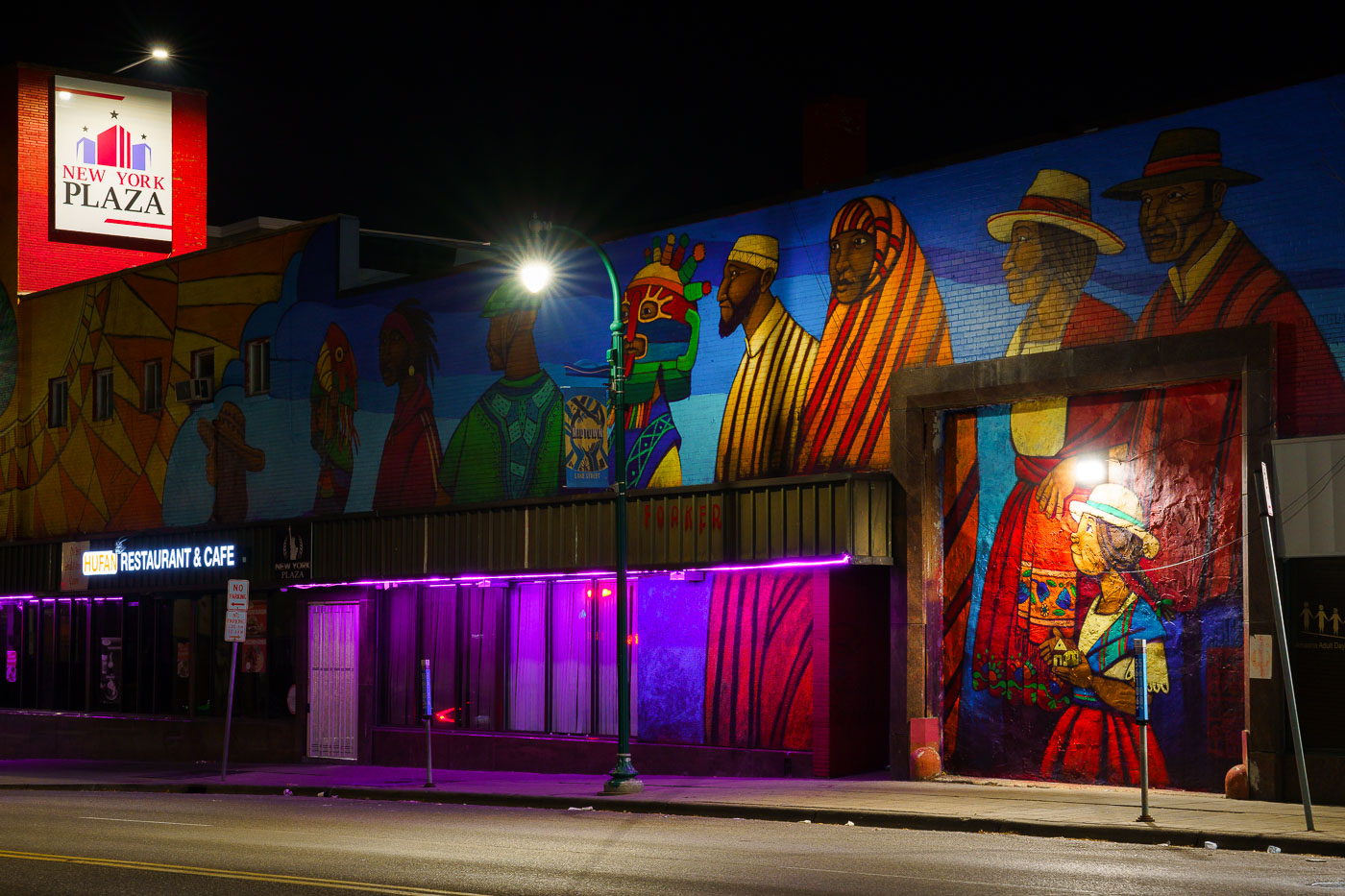 Large 2 story mural on street at night
