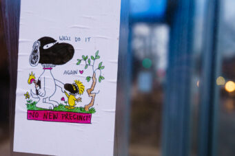 Flyer of Snoopy saying "We'll do it again" and "No New Precinct" seen on the Midtown Greenway in Minneapolis. Flyers are in protest of a new Minneapolis police police station rebuild after protesters burned the previous one on May 28th, 2020.
