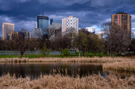 Storm clouds roll over Minneapolis as seen from Loring Pond near Downtown.