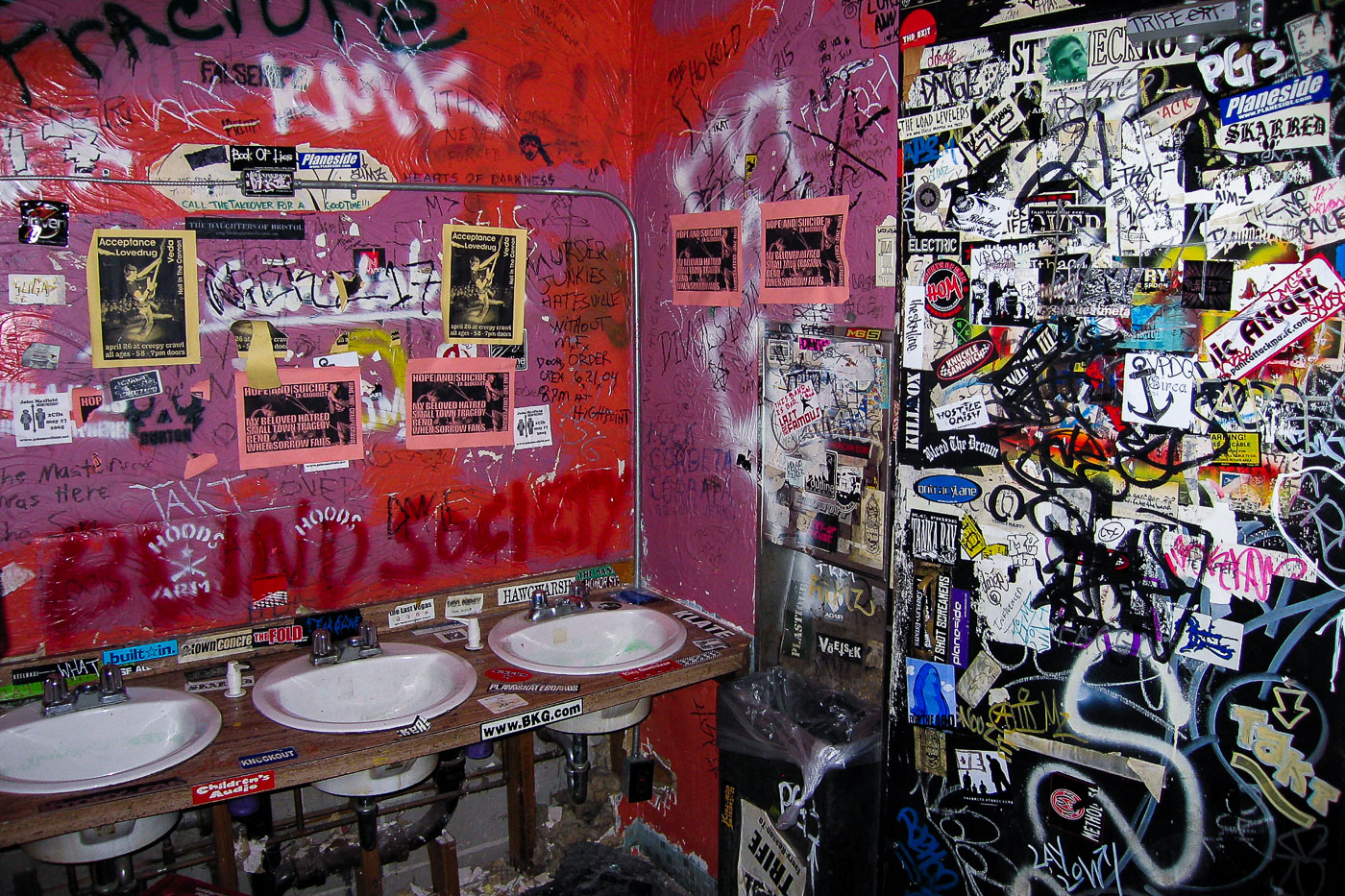 Creepy Crawl club bathroom with stickers
