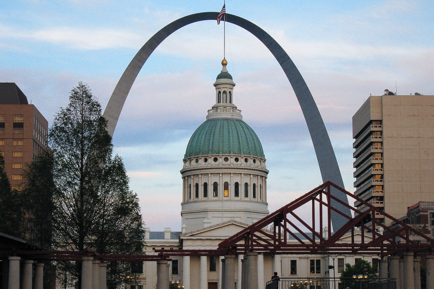 The Gateway Arch, a stainless steel curve, stands behind the Old St. Louis County Courthouse in St. Louis, Missouri. The Arch commemorates westward expansion, and the Courthouse was the site of the Dred Scott case.