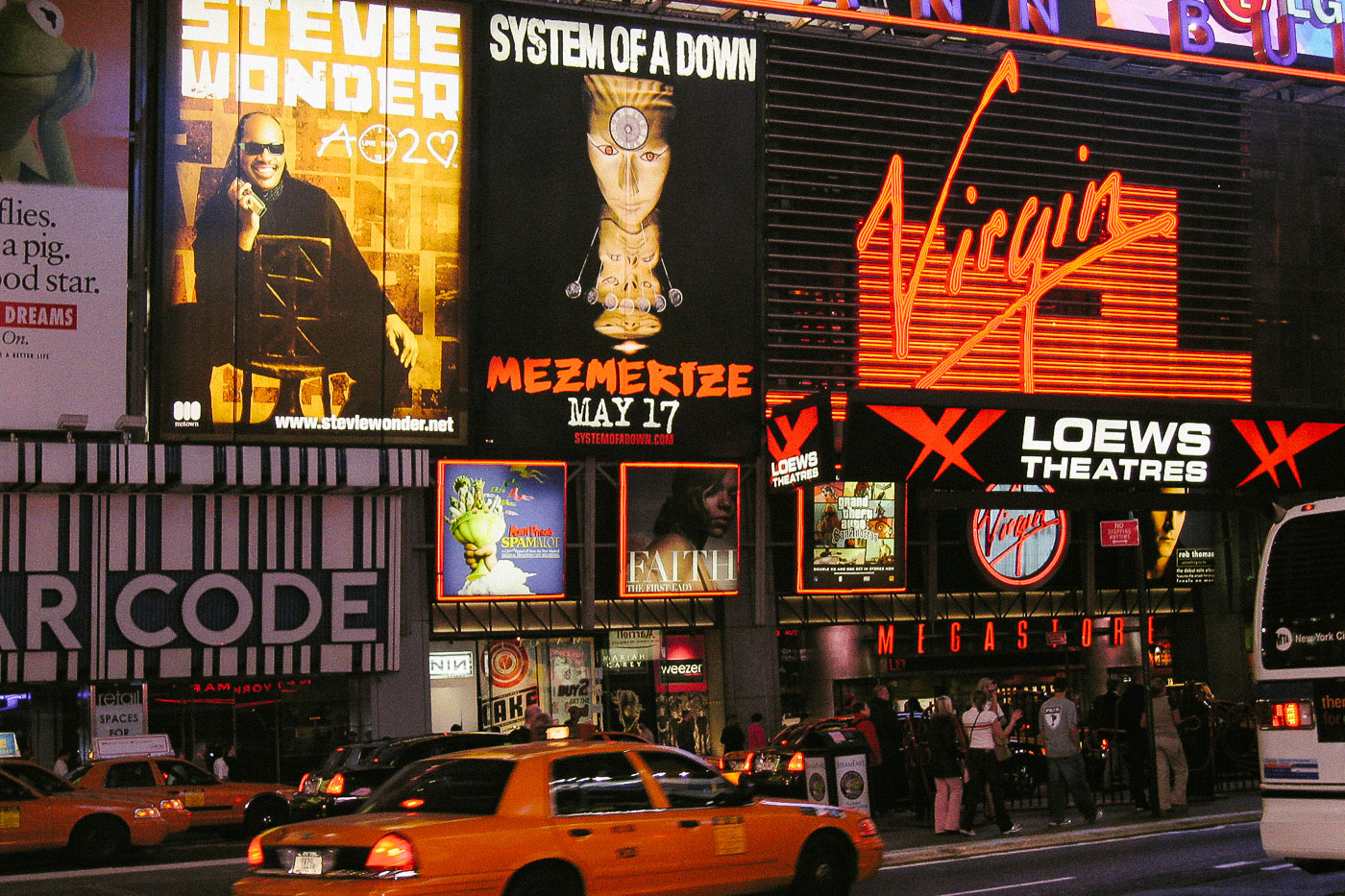 Taxis drive by the Virgin Megastore in Times Square