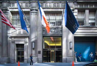 Woman walks in front of the New York Times building in May 2005.