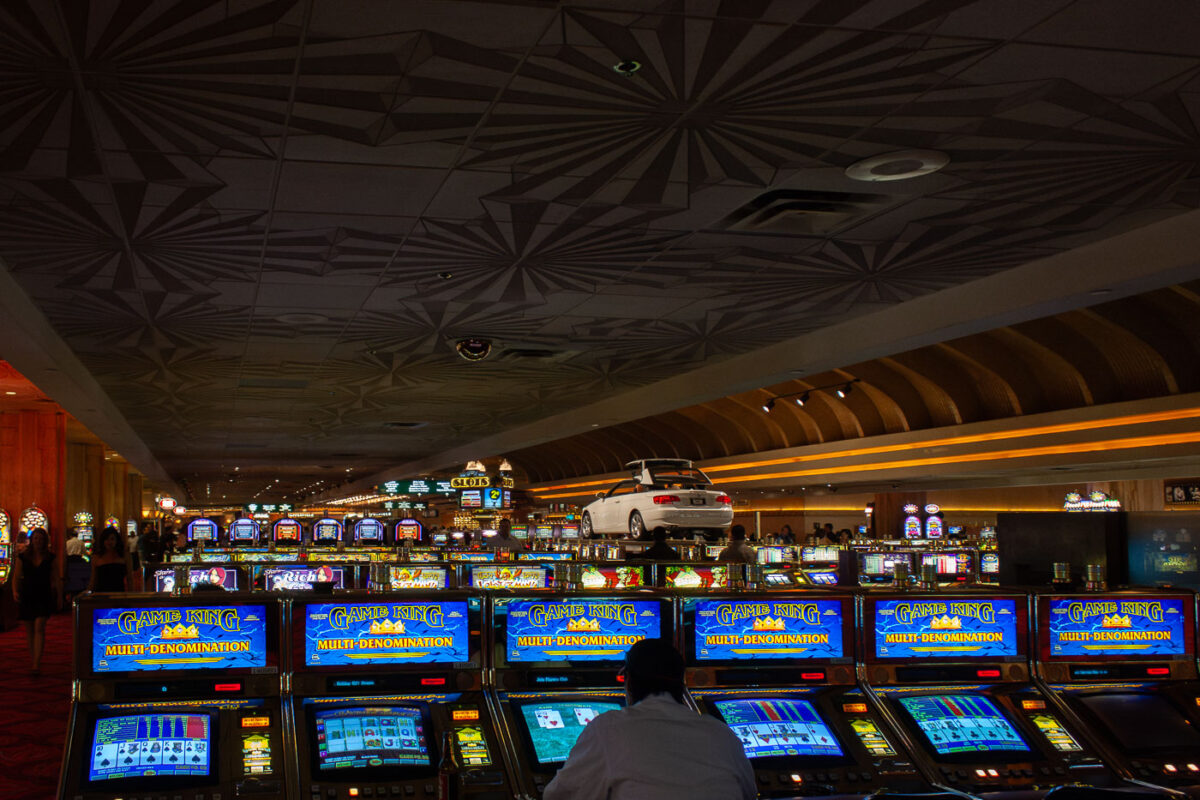 A man plays slot machines at a Las Vegas casino.