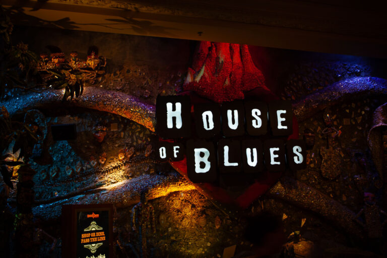 House of Blues Las Vegas Neon Sign and Decor 1 The House of Blues is a chain of music venues and restaurants founded in 1992, with its Las Vegas location opening in 2007. The venue is known for its eclectic decor, which often incorporates folk art and memorabilia, creating a unique atmosphere for patrons. It hosts a variety of musical acts, from local bands to national headliners, and serves as a popular entertainment destination on the Las Vegas Strip. The interior design, as seen in this image, features a distinctive mosaic-like wall and illuminated signage, contributing to its vibrant and immersive experience.