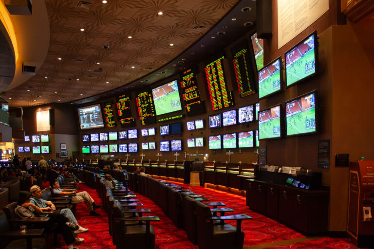 Las Vegas Casino Sportsbook Screens and Seating 1 Rows of seats face large screens in a Las Vegas casino sportsbook, displaying live sports and betting odds.