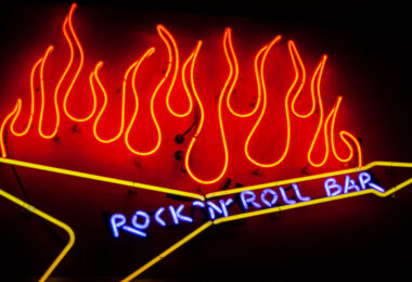 Neon sign that reads "Rock 'N' Roll Bar" with flames.