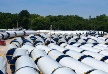 Vestas windmill parts in a railyard.