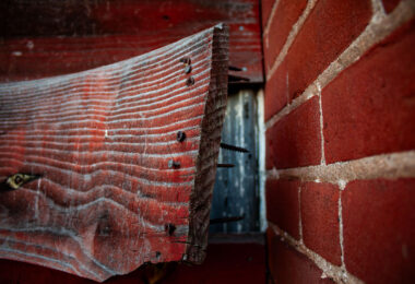 A board coming off an abandoned building.