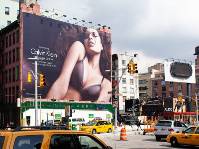 Taxis Pass a Calvin Klein Billboard in SoHo